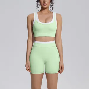 Front view detail of a mint green ribbed high waist yoga set with white contrast trim