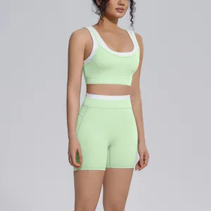 Two-piece mint green yoga set featuring a sports bra and high-waisted ribbed shorts.