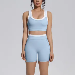 Front view of a light blue and white color-blocking high-waisted yoga set on a model.