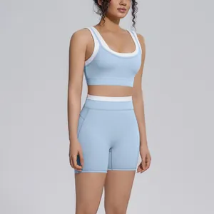 Two-piece light blue color-blocked yoga set with high-waisted shorts and sports bra