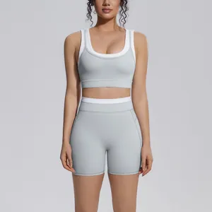 Detail view of a grey and white color-block high-waist yoga sports bra and shorts set