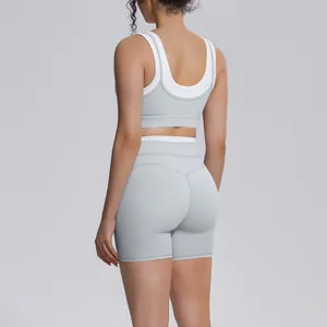 Rear view of grey color block yoga set featuring U-back sports bra and high-waisted shorts.