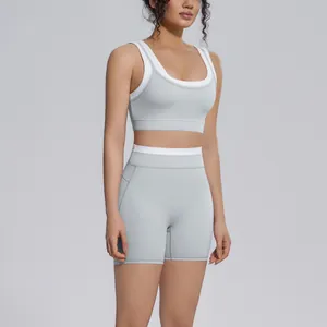 Detailed view of women's grey and white two-piece yoga set featuring high-waisted shorts