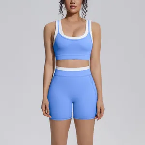 Frontal view of a women's blue and white color-block ribbed high-waist yoga sports bra and shorts set