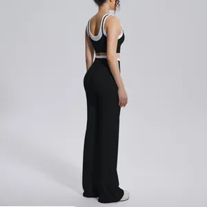 Side profile view of a black high-waisted yoga set featuring contrast white trim detail