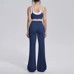 Back view of blue and white color-blocked yoga set with high-waisted flared pants