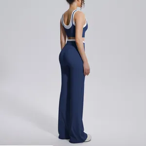 Side view of a navy blue color block yoga set featuring sports bra and flared pants