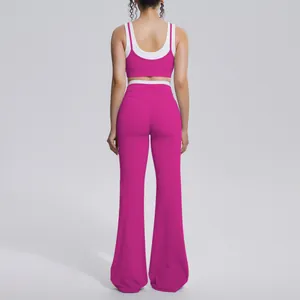 Back view of a hot pink and white color-blocking yoga set with high-waisted flared leggings