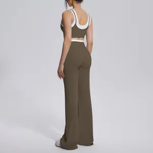 Back view of two-piece color-block yoga set featuring sports bra and flared leggings