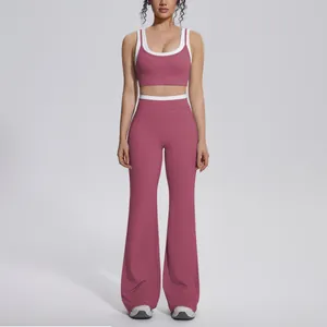 Front view of a dusty rose yoga set with white trim sports bra and flared pants