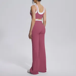 Back view of pink color-block yoga set with high-waist flared pants and sports bra.