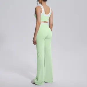 Back view of mint green ribbed yoga set with high-waisted wide-leg trousers and contrast bra.