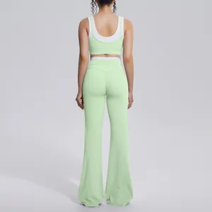 Back view of mint green and white contrast yoga set including sports bra and flared pants.