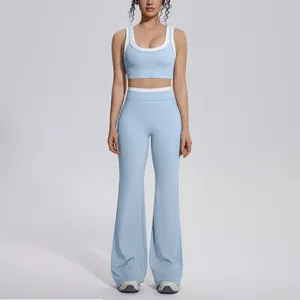Full-body view of light blue color-blocked yoga set with sports bra and flared pants