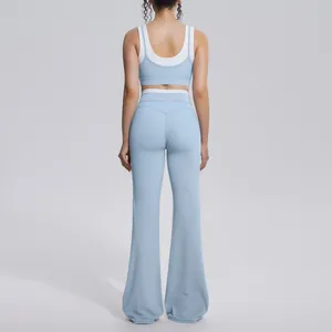 Back view of light blue color-blocked high waist yoga set with flared pants for women