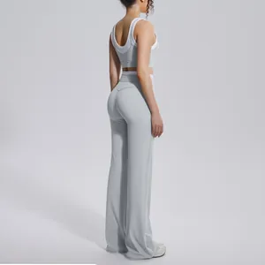 Detail view of a light grey contrast high waist yoga set on a model back side view.