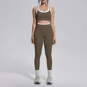 Close-up front view of a two-piece olive green yoga set with white contrast trim
