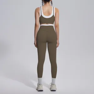 Back view of brown and white color block yoga set with high waist leggings and sports bra