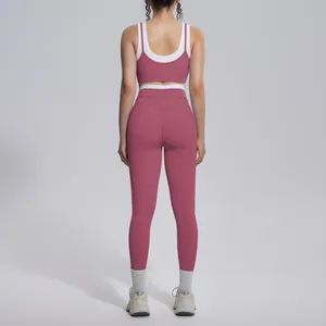 Back view of a dusty rose and white contrast yoga set featuring high-waisted leggings.