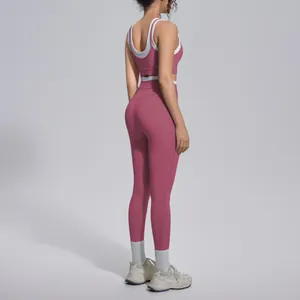 Back view of pink contrast trim yoga set showing high waist ribbed leggings and bra.