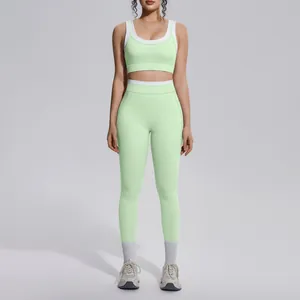 Detailed front view of a mint green yoga set with white contrast trim on a fitness model