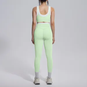 Back view of mint green color-blocked yoga set featuring high waist leggings and sports bra.