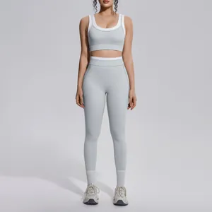 Full view of light gray yoga set with white contrast trim on a fitness model