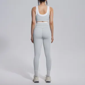 Detailed back view of a high-waisted grey yoga set with contrast white trim for fitness