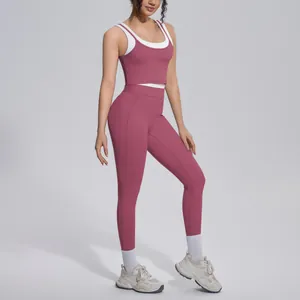 Two-piece pink and white contrast yoga set featuring sports bra and high waisted leggings