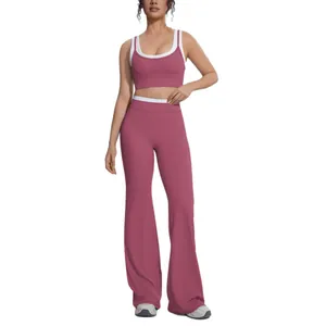 Women's dusty rose and white contrast yoga set with ribbed sports bra and flared leggings