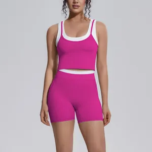 Two-piece pink and white colorblock yoga set with high waist shorts and crop top