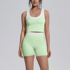 Women's mint green layered sports yoga set with high-waisted shorts and cropped tank top