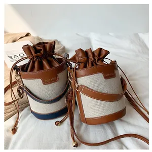 Two stylish drawstring bucket bags in canvas and leather for a chic daily look
