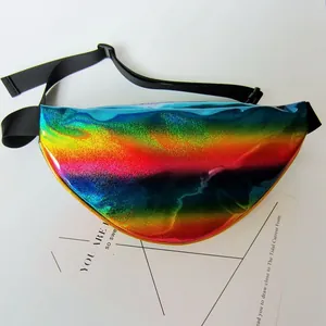 Close-up of holographic rainbow waist bag with black adjustable strap on white card