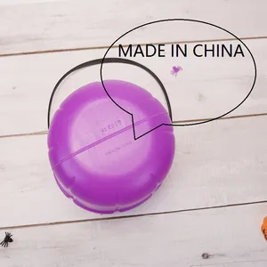 Vue détaillée du fond d'un seau à bonbons citrouille d'Halloween violet avec anse