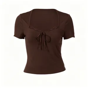 Front view of brown slim-fit T-shirt featuring lace trim and tie-front detail.