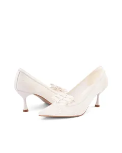 Elegant off-white lace pointed-toe pumps with delicate bow detail and kitten heels.