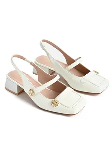 Elegant cream white square-toe slingback pumps featuring chunky heels and gold buttons.