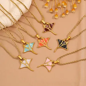 Detailed close-up of various colorful manta ray pendant necklaces with gold twisted rope chains