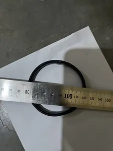 Detail shot of black metal spring arm band being measured with a stainless steel ruler