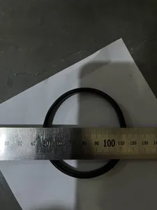 Measurement detail of a black metal spring arm ring with a ruler showing diameter.