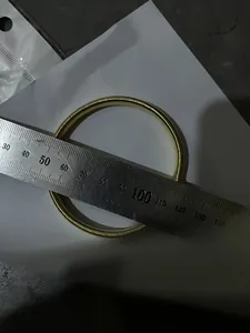 Detail showing diameter measurement of gold metal spring armband sleeve garter