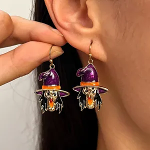 Close-up detail of Halloween gothic witch drop earrings with purple enamel hat