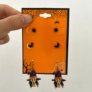 Detailed view of a Halloween earring set featuring black bats and purple witches