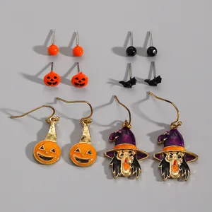 Halloween earring set featuring pumpkin, witch, and bat designs on grey background