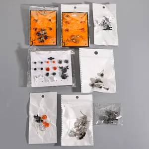 Collection of Halloween themed earrings with ghost and pumpkin designs in packaging
