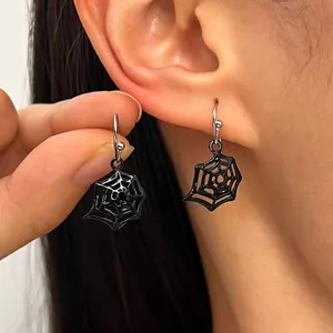Close-up of gothic black spider web drop earrings worn on ear for Halloween costume