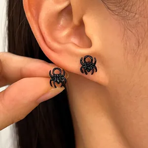 Detailed macro view of black gothic spider stud earrings for Halloween costume jewelry