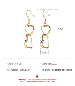 Detailed view of hollow heart drop earrings with size and material specifications
