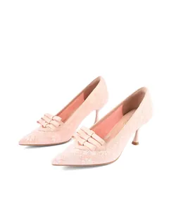 Detail view of elegant pink lace pointed-toe high heels with a stylish layered bow accent